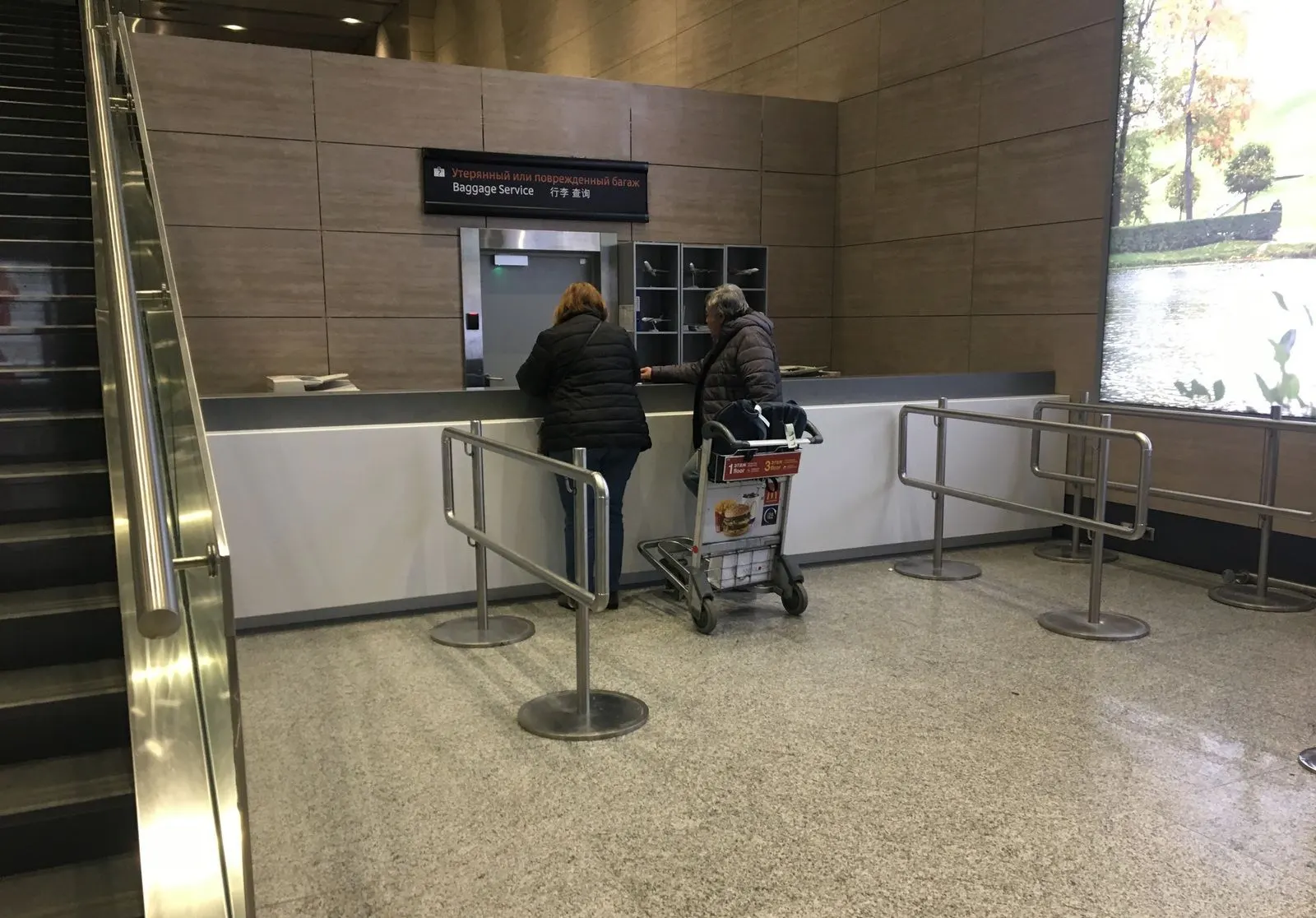 Service counter in white solid surface in an airport arrivals area