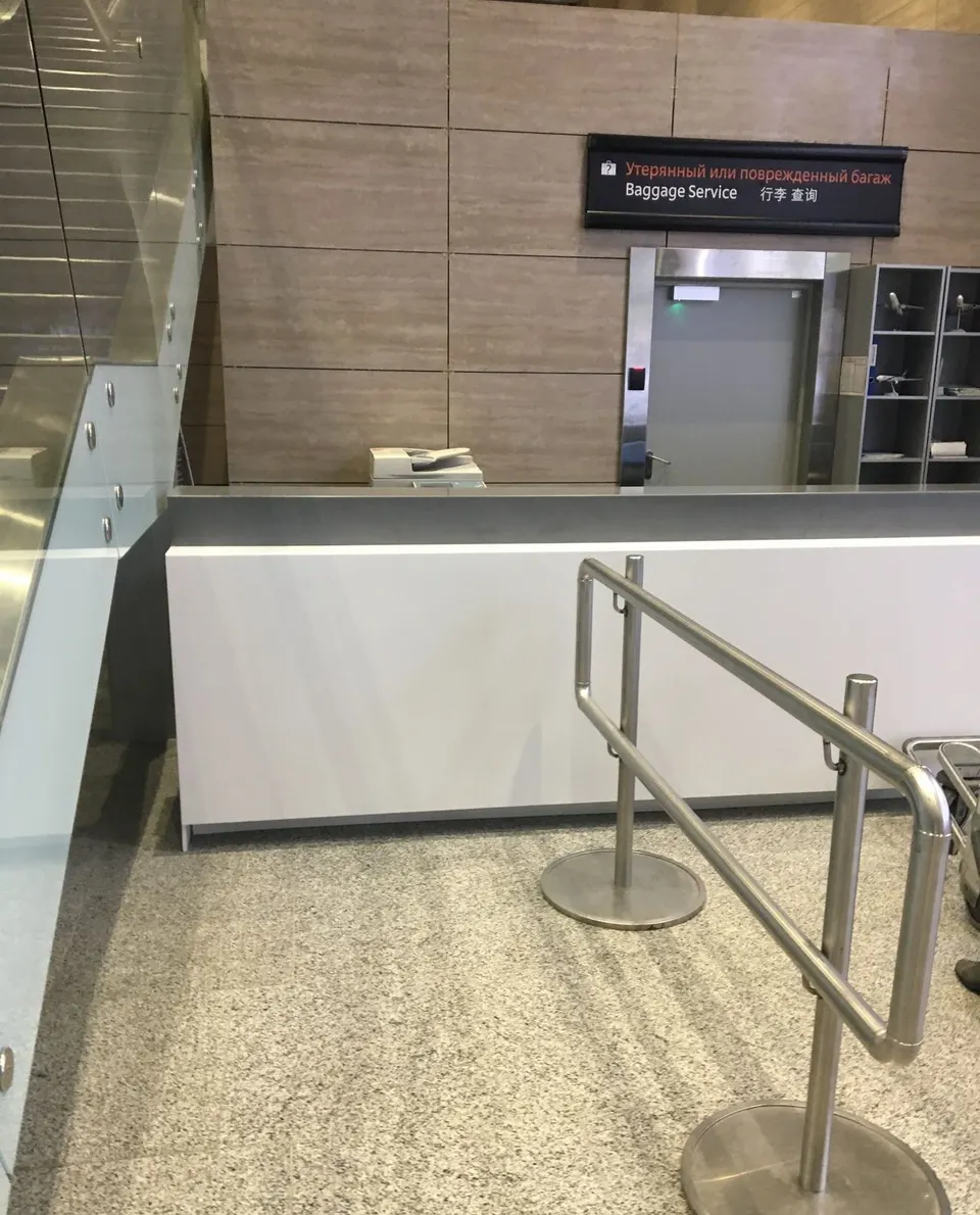 White solid surface service counter with dark worktop in an airport terminal
