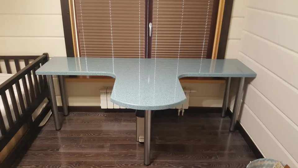 Solid surface desk with a curved return on steel legs