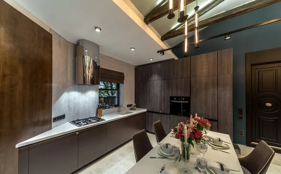 Kitchen with a light solid surface worktop and island