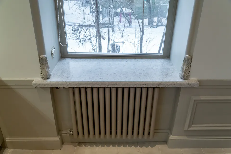 Veined solid surface window sill with decorative corbels